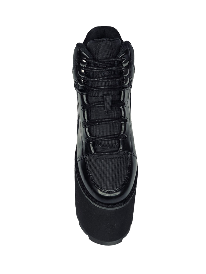 top view of black vegan leather platform shoe with EVA platform. Shoe looks like a sneaker, but super tall! Shoe has nylon details and mesh lining. Bottom of platform has a "fanned" grip to make the platform more stable.