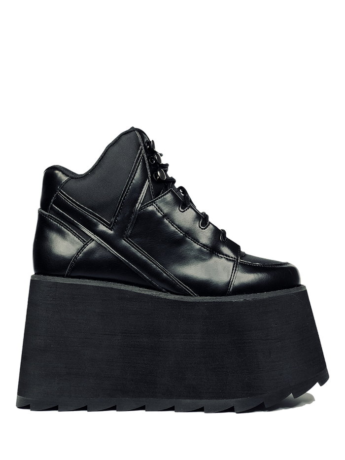inner view of black vegan leather platform shoe with EVA platform. Shoe looks like a sneaker, but super tall! Shoe has nylon details and mesh lining. Bottom of platform has a "fanned" grip to make the platform more stable.