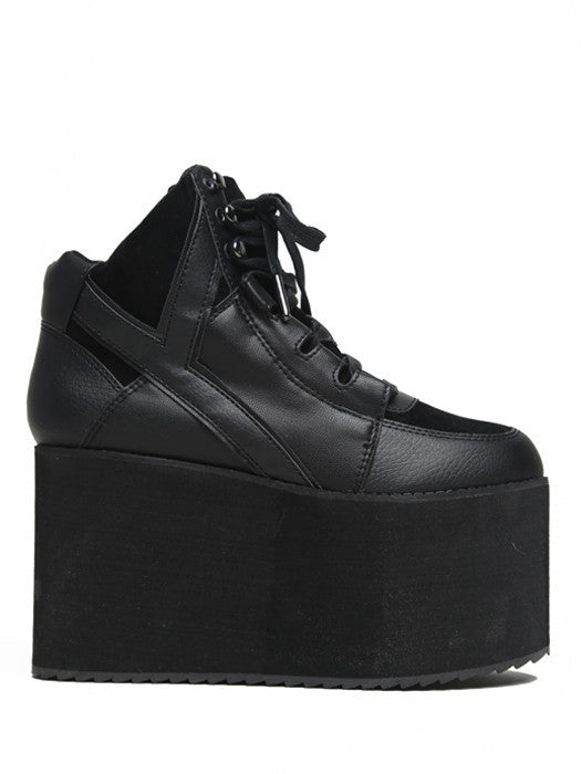 outer view of black vegan leather platform shoe with EVA platform. Shoe looks like a sneaker, but super tall! Shoe has mesh lining.