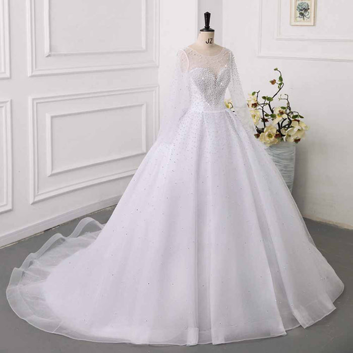 Elegant sweetheart tulle wedding dress with sheer long sleeves and sparkling embellishments