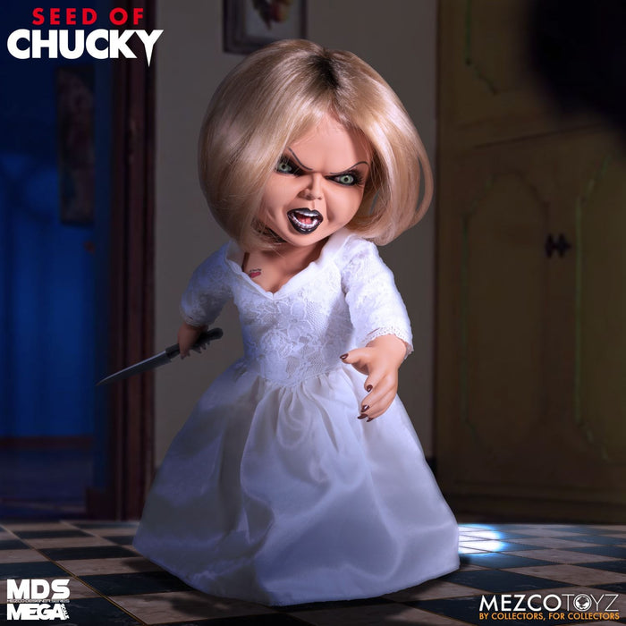 Tiffany doll is outfitted in an all-white gown and choker necklace. Doll comes complete with a knife accessory that fits nearly in her right hand.
