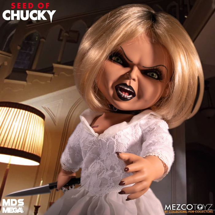 Tiffany doll is outfitted in an all-white gown and choker necklace. Doll comes complete with a knife accessory that fits nearly in her right hand.