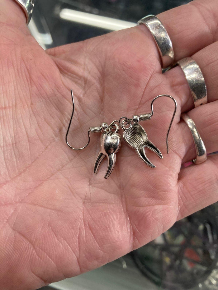 model holding earrings
