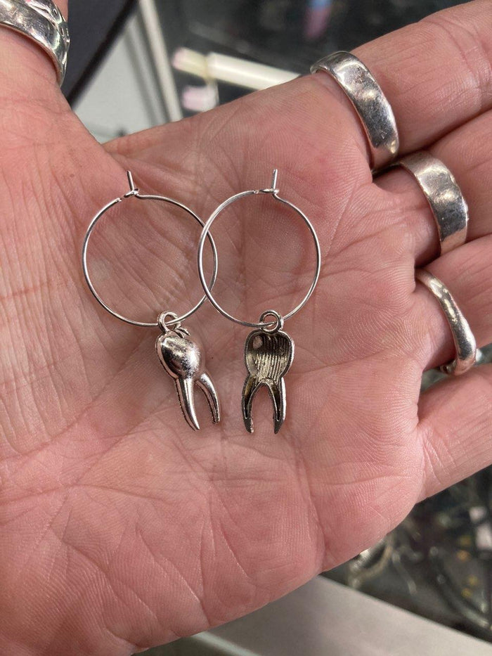 model holding earrings