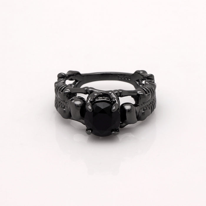 Black skeleton band and large black cubic zirconia on top center.