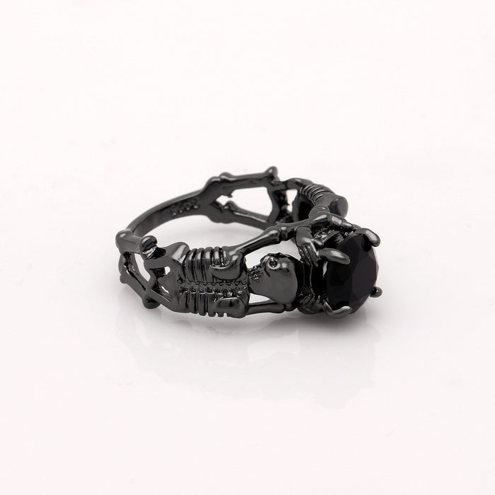 Black skeleton band and large black cubic zirconia on top center.