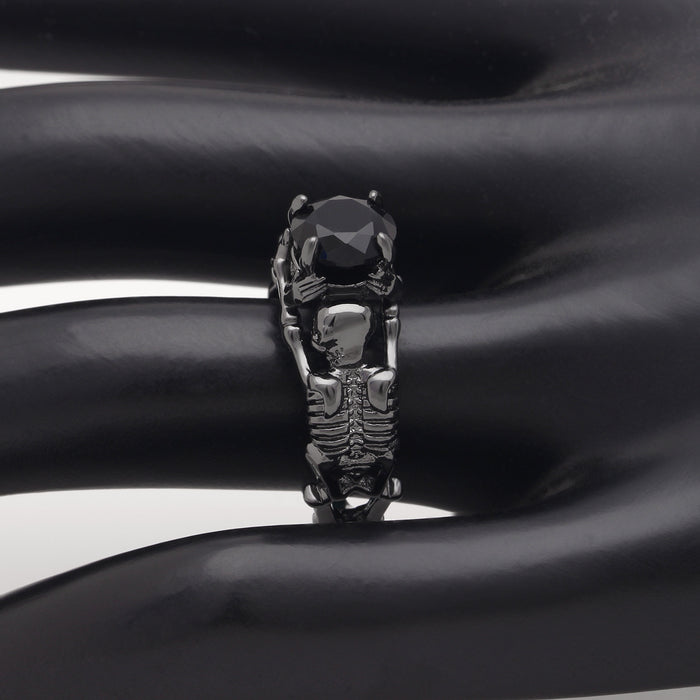 Black skeleton band and large black cubic zirconia on top center.