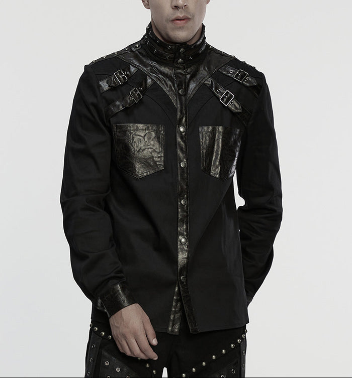 Person wearing a black, detailed shirt on a plain background