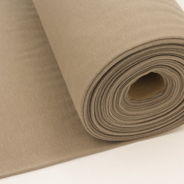 Roll of beige fabric on a white background