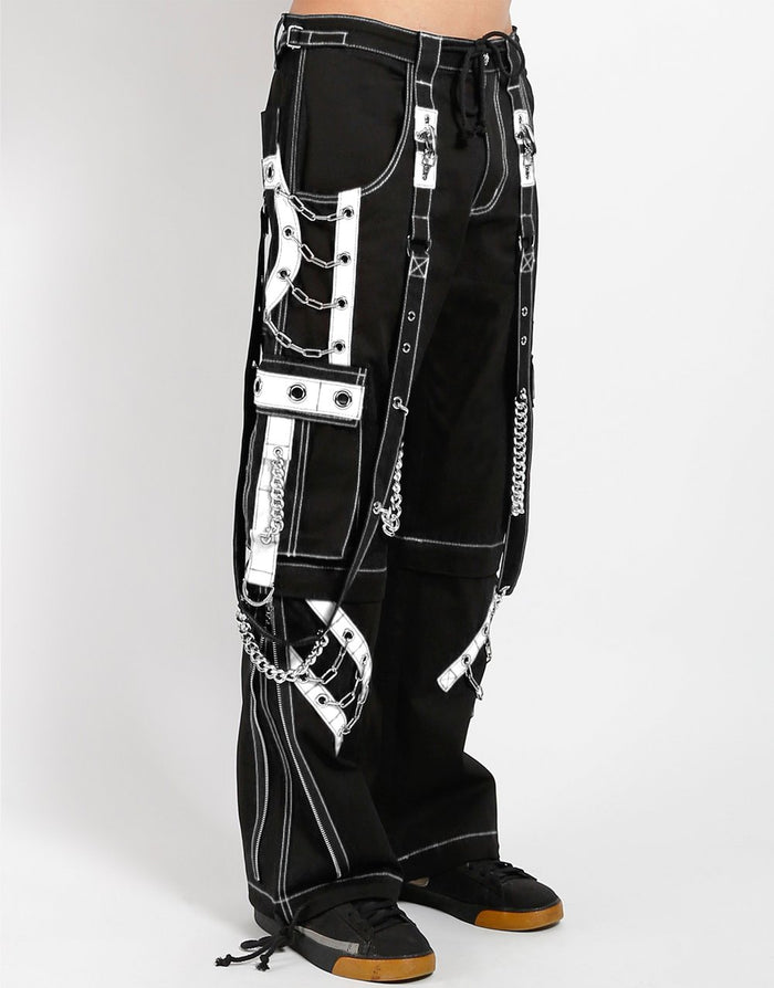 side of Black and white pants feature white stitching, removable straps, adjustable ankles, D-rings, clasps, and deep pockets.