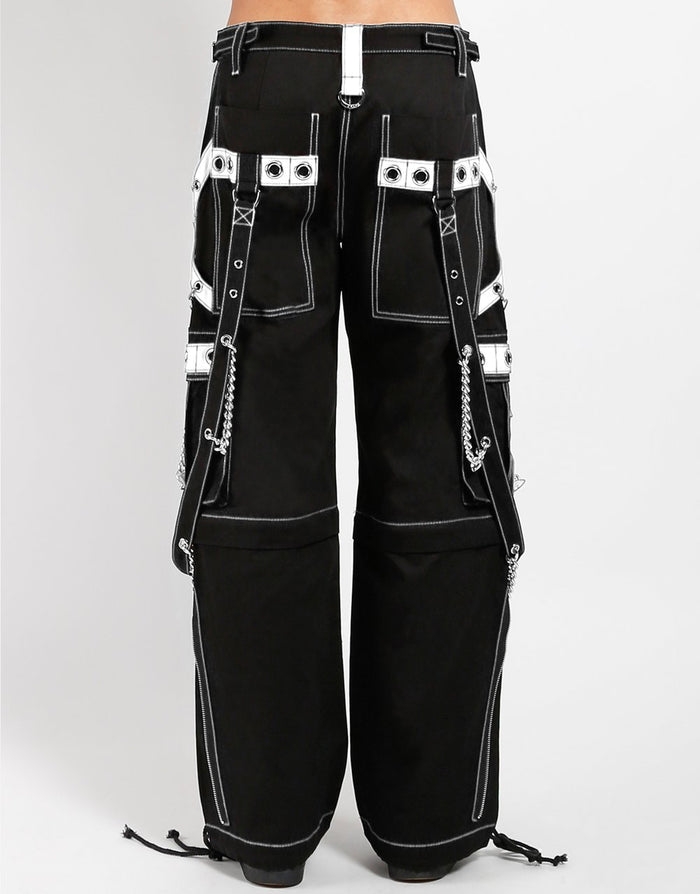 back of Black and white pants feature white stitching, removable straps, adjustable ankles, D-rings, clasps, and deep pockets.