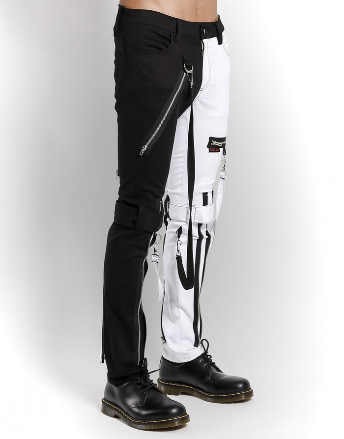 side of Classic slim White/Black split leg pants with removable bondage straps and zipper details. Pant legs can be zipped for a change in fit, topped off with a zip fly and button closure.
