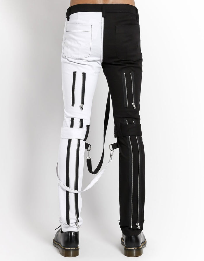 back of Classic slim White/Black split leg pants with removable bondage straps and zipper details. Pant legs can be zipped for a change in fit, topped off with a zip fly and button closure.