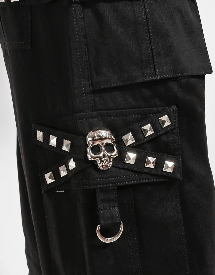 Waist-down view of baggy black punk-style cargo pants featuring silver pyramid studs, hanging side straps, a drawstring waist, and chunky black boots against a white background.