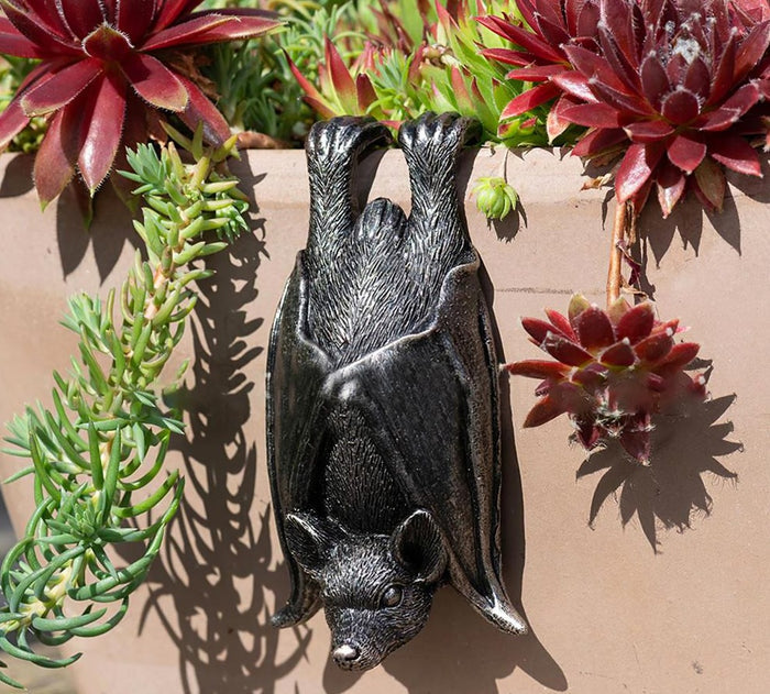 Upside down gray resin hanging bat statue.