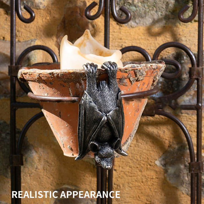 Upside down gray resin hanging bat statue.