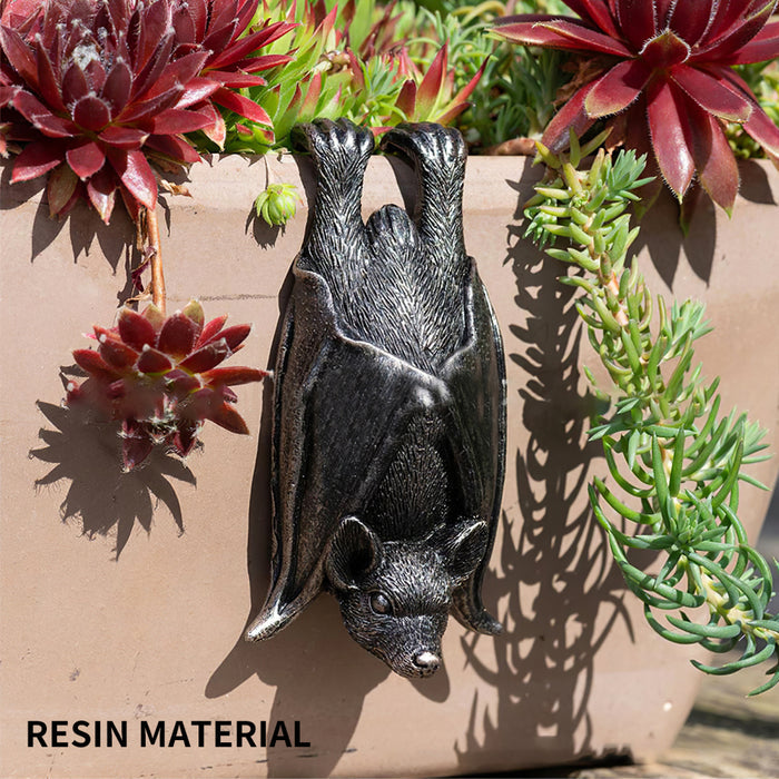 Upside down gray resin hanging bat statue.