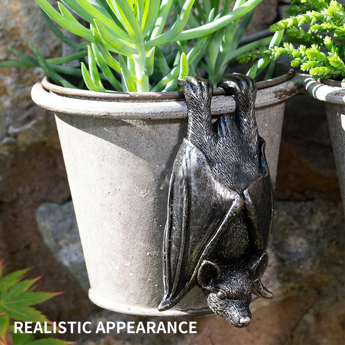 Upside down gray resin hanging bat statue.