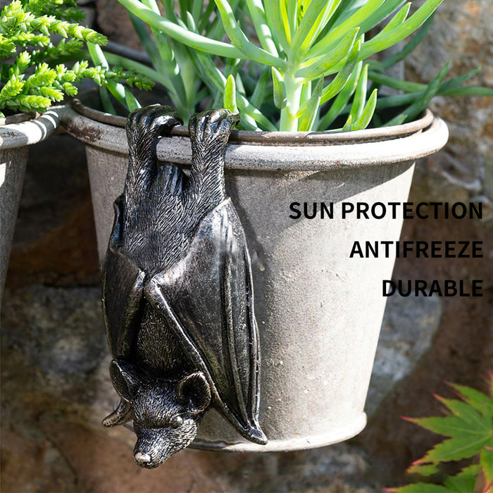 Upside down gray resin hanging bat statue.