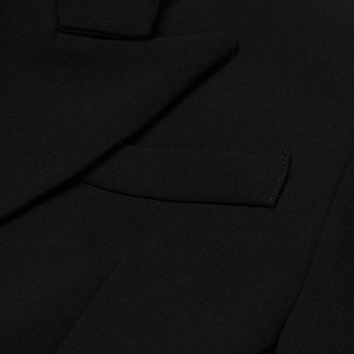 Close-up of women's black maxi blazer coat showing premium fabric and sleek design features